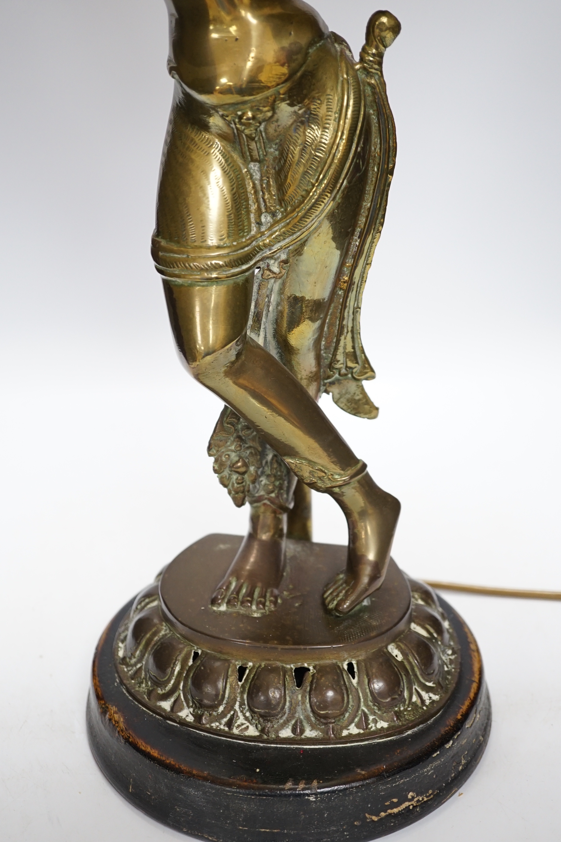 A vintage Indian polished brass figure of a dancer on lotus base, now mounted as a lamp, 80cm including shade